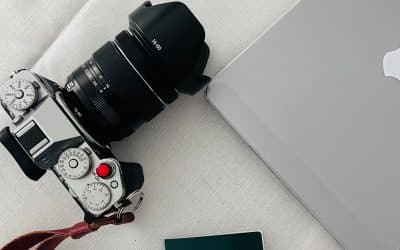 Passport, laptop, and camera arranged for international travel planning