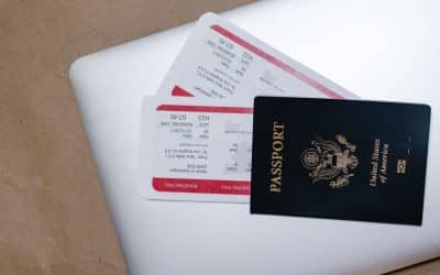 Passport and boarding passes arranged on a laptop