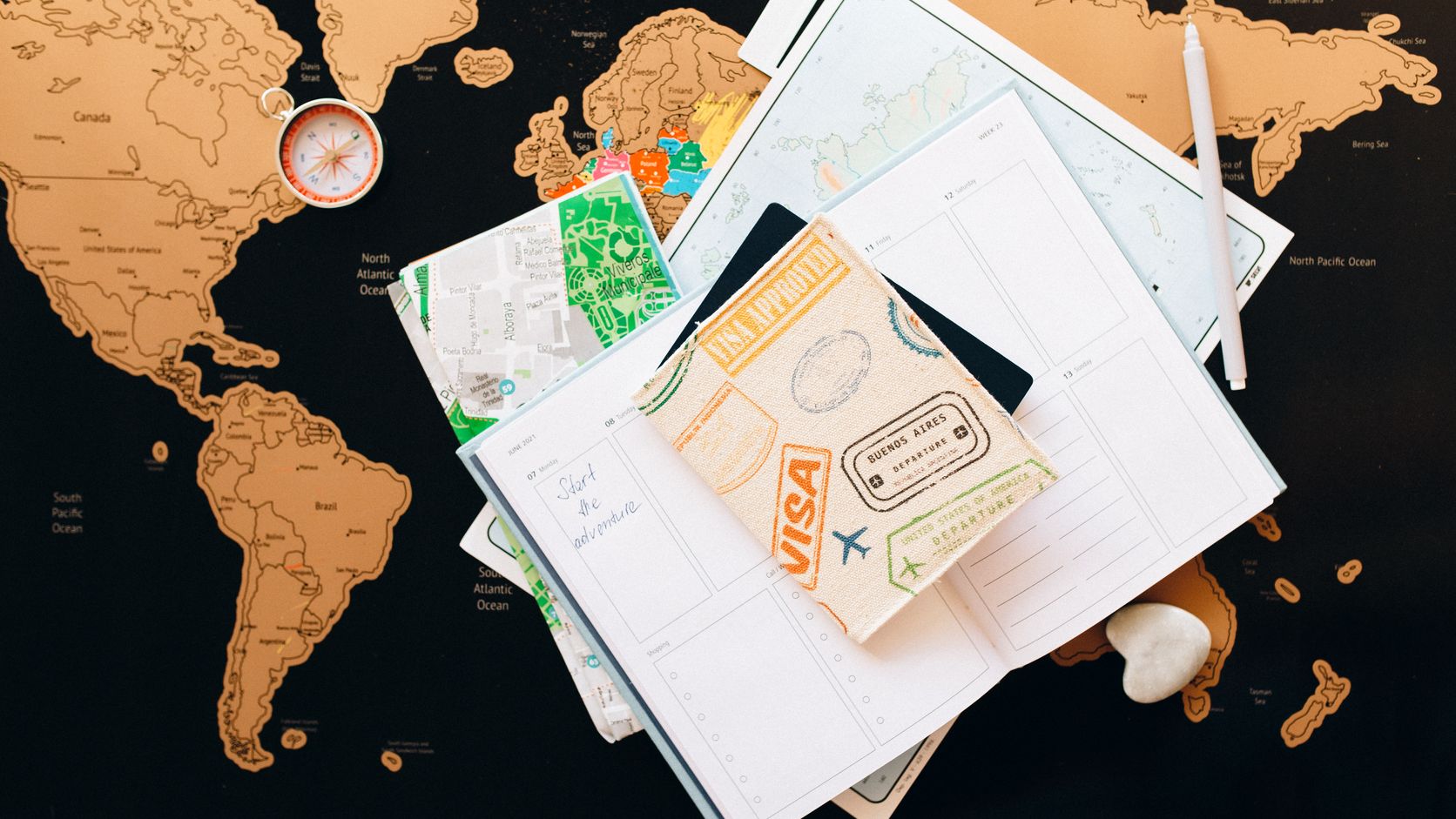 Passport and travel planner arranged on a map