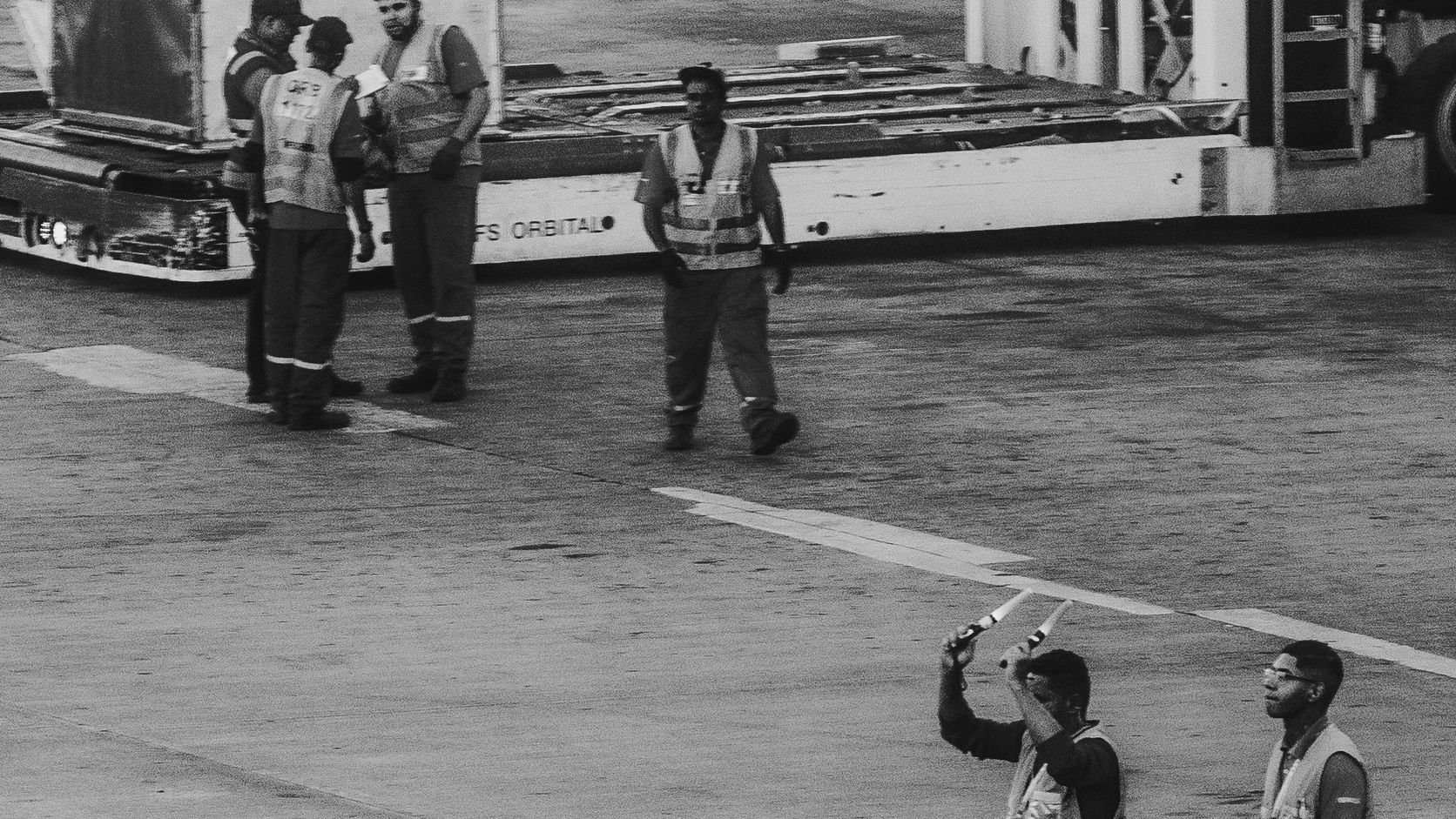 Ground crew member directing an airplane on the tarmac