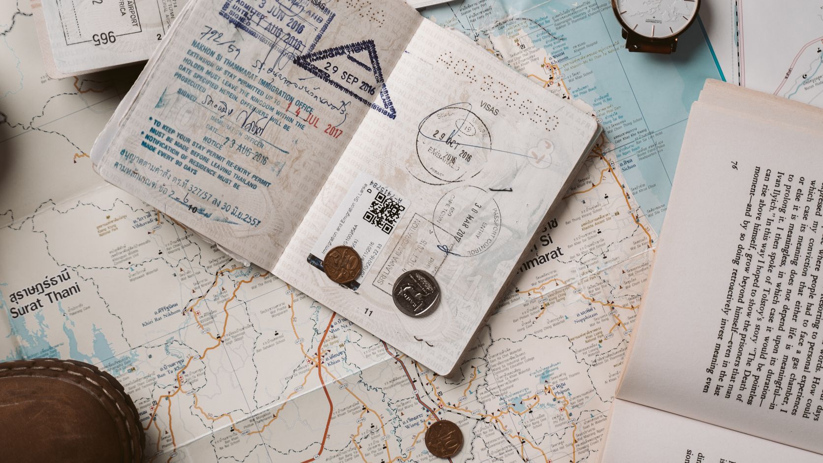 Passport, map, and travel documents arranged on a table