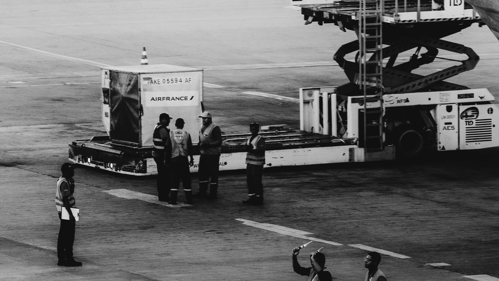 Ground crew coordinating luggage loading at an airport